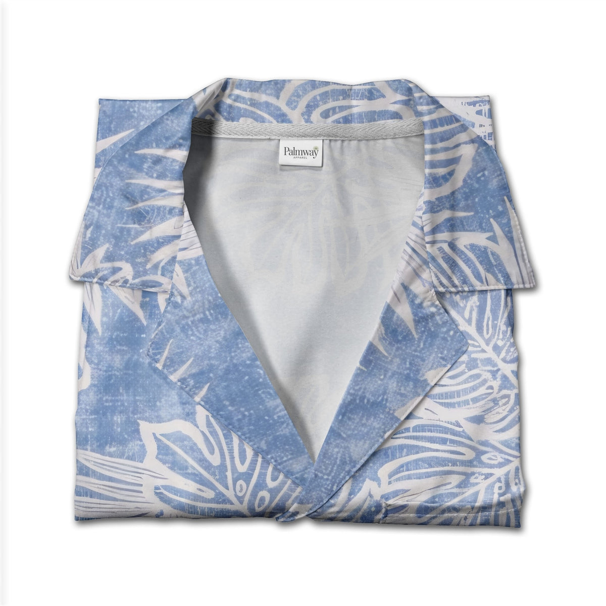 Textured blue Hawaiian shirt with monstera leaves and palm fronds in white outline art