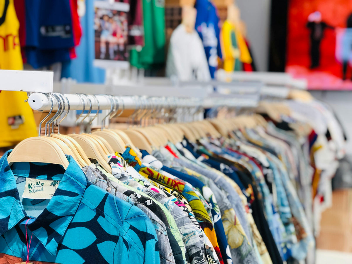 Hawaiian shirts for sale in store, tropical print shirts on rack for summer fashion and vacation wear